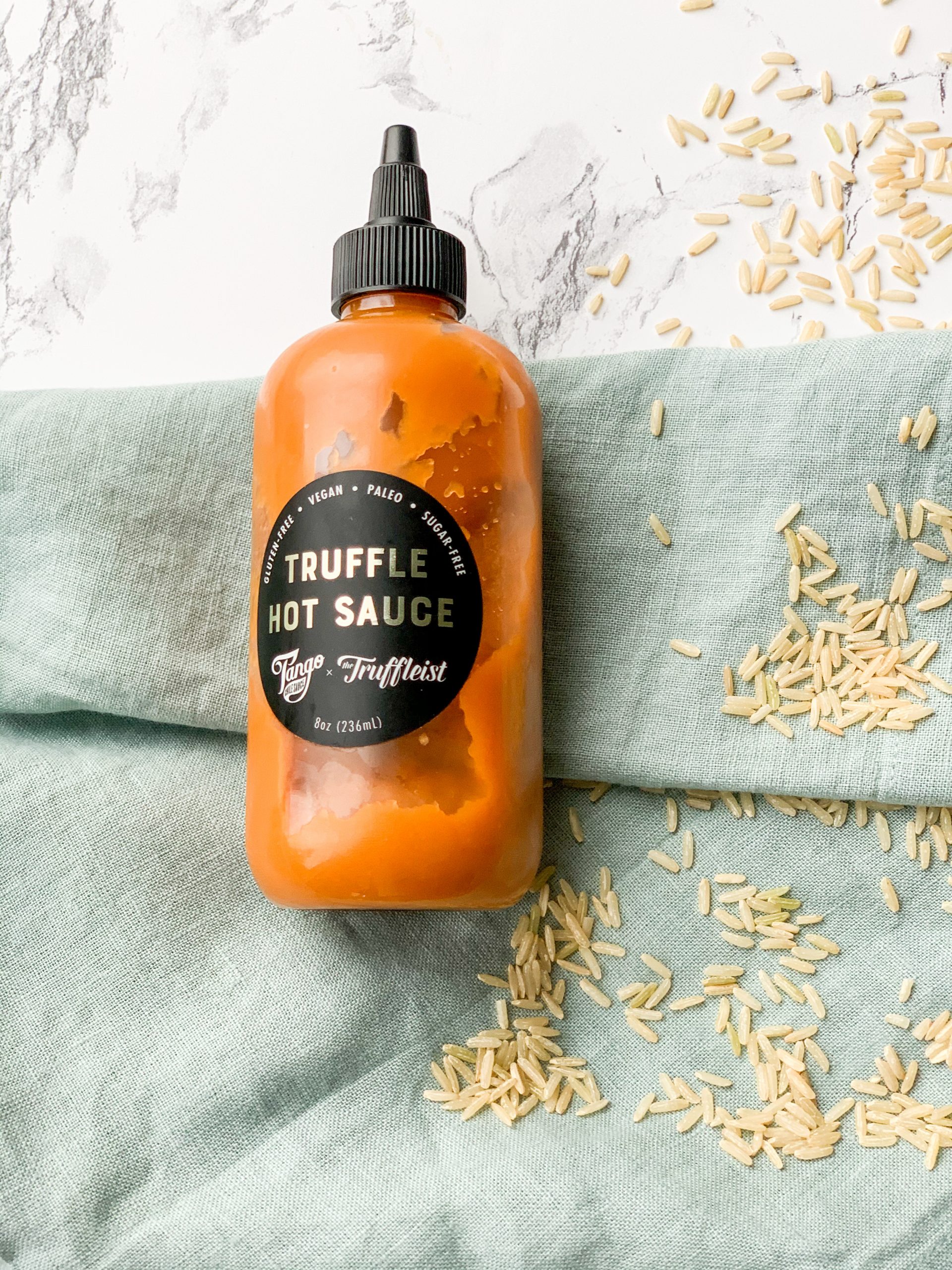 truffle hot sauce in a bottle on a blue napkin