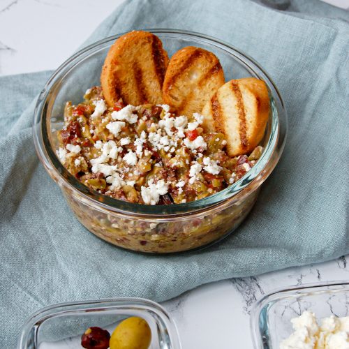 3 crostini in feta and olive tapenade served in a bowl