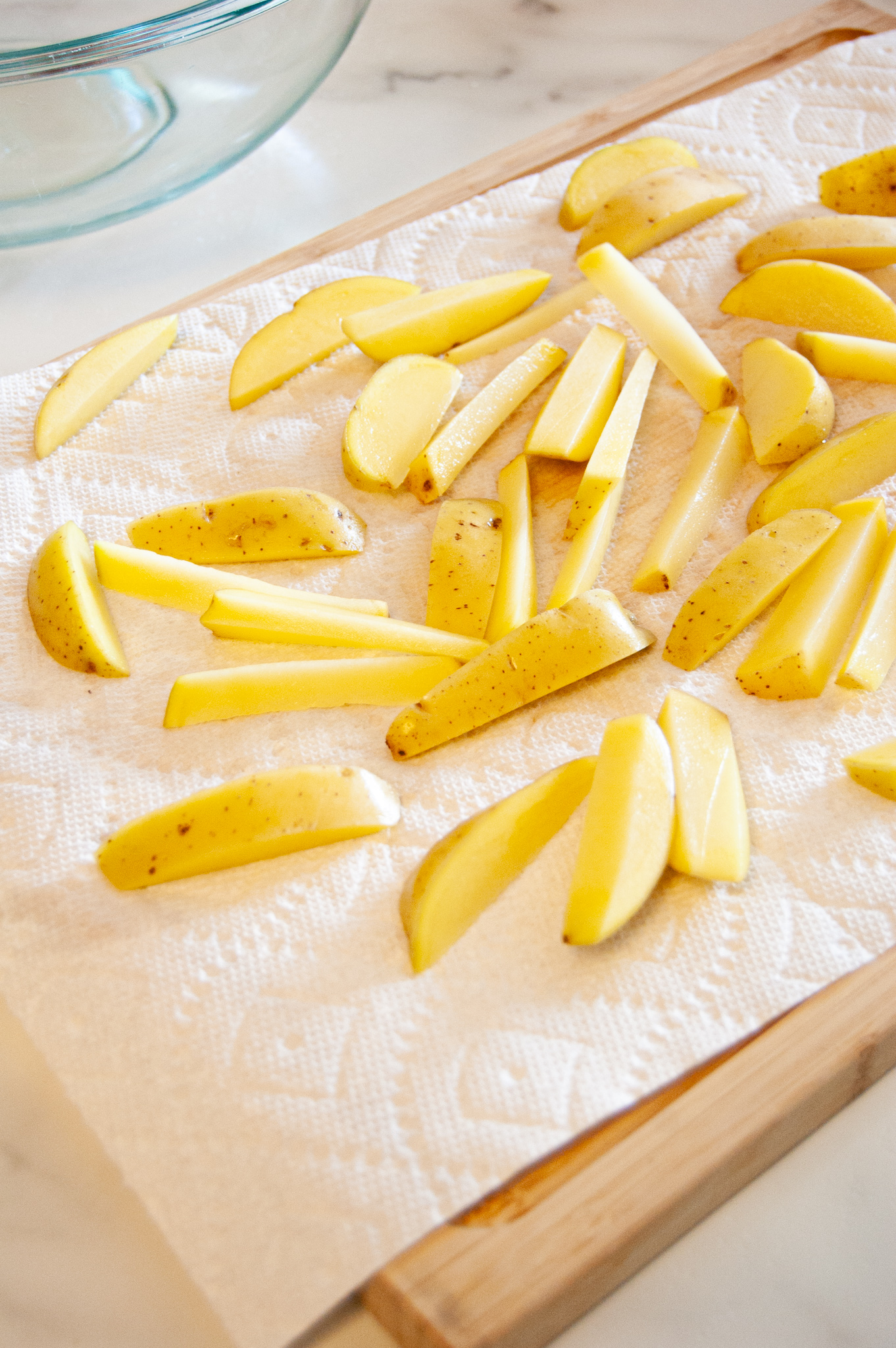 Sliced potatoes drying on paper towel